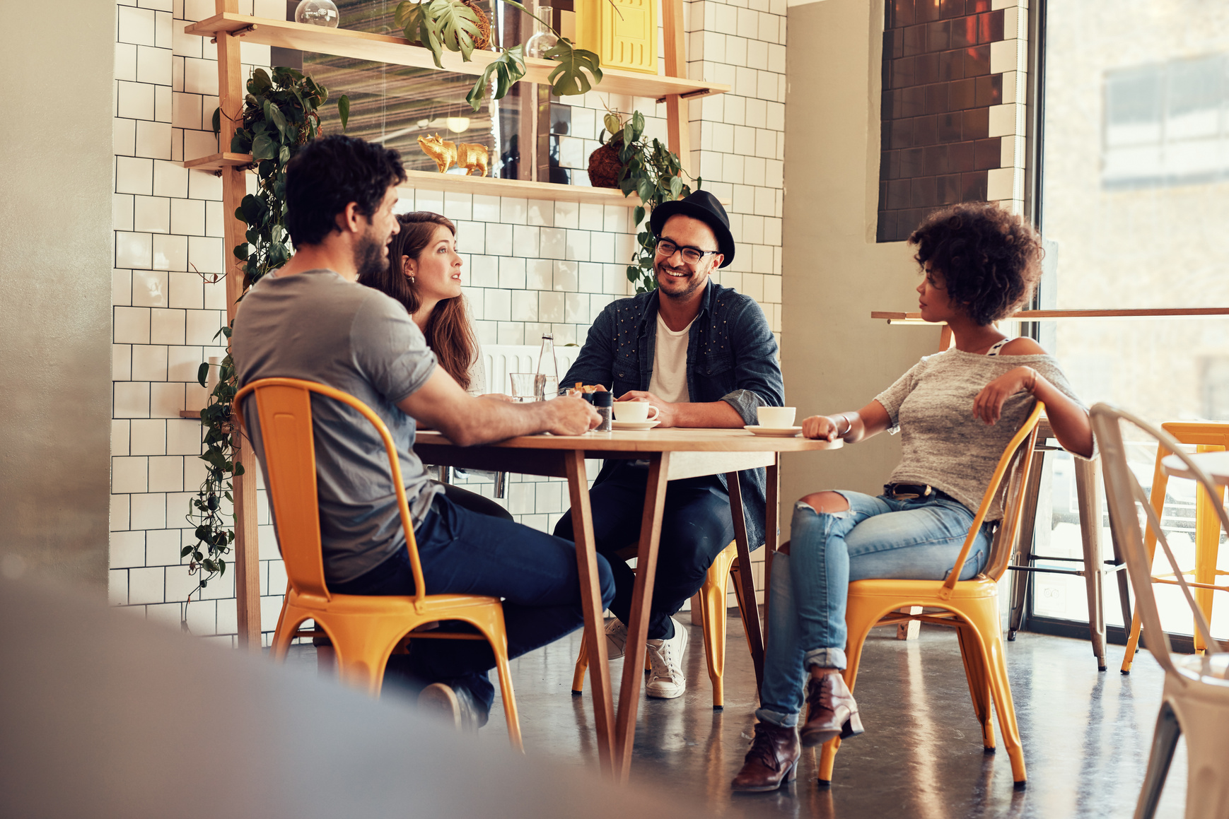 Young People Sitting at a Cafe Table